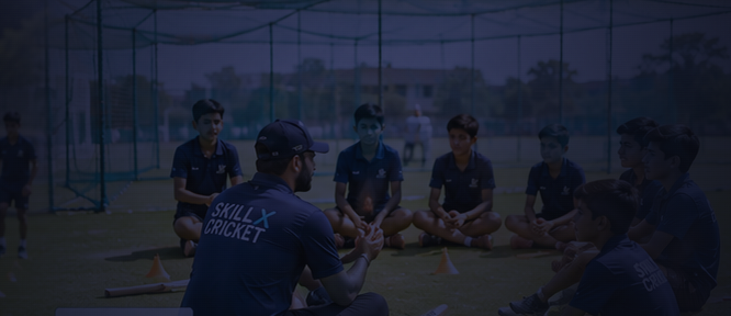 A coach and young players in an open session at the nets